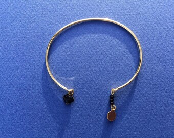 Bangle is gold with black sequin and beads