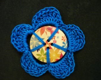 Flower crocheted around a colorful wooden button