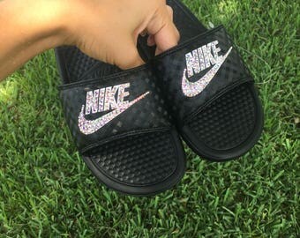 black nike slides with gold swoosh