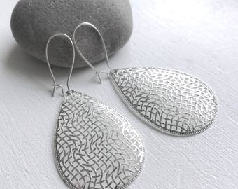 Dangle Silver earrings with design engraved pendant