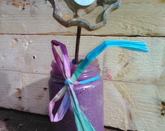 Tap flower in purple vase