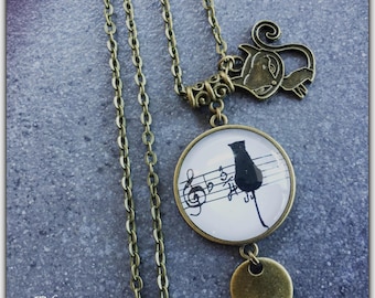 Poured glass cabochon, cat, sheet music, black and white