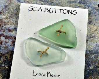 A pair of glowing light green sea foam triangle shaped natural Maine sea/ beach glass buttons artisan eco-friendly statement for sweaters