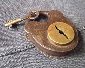 Antique lock with iron body and brass center disk