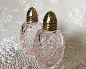 Vintage pink glass salt and pepper shakers w brass lids