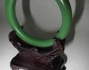 A beautiful piece of natural green jade bangle with stand