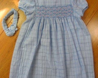 Little girl's blue smocked dress with matching headband and flower decoration for 4-5 years old.