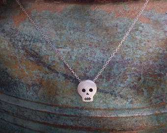 Tiny sterling silver skull necklace