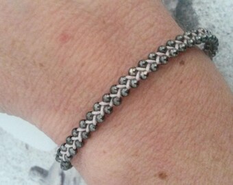 Braided light pink and black bracelet
