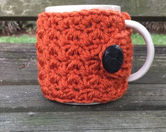 Crochet mug cozy button wrap in burnt pumpkin
