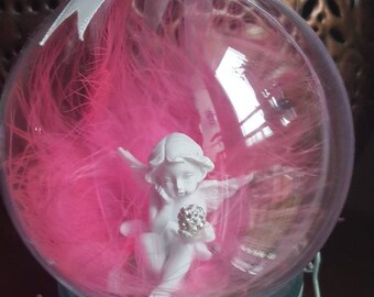 Beautiful angel ornament with pink feathers inside a large baubles hanging decoration