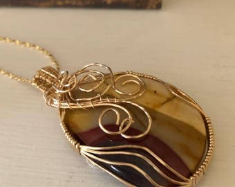 Mookaite Pendant with intricate wire wrap. Mookaite properties are Grounding, Confidence, Decision-making