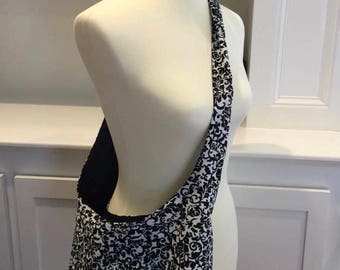 Black & White Reversible Cross Body Bag with Adjustable Strap and Pocket.
