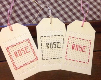 Set of 3 pink tags embroidered name.