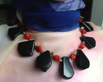 A very special black, red, beige handmade necklace of ancient jet, bambou de mer, and keshi with yellow copper coloured nickelfree clasp