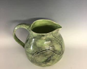 Green ceramic wheel thrown pitcher