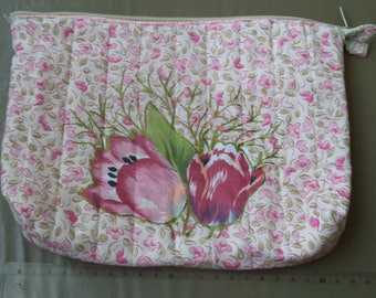 case padded with pink flowers with a zipper
