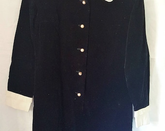 1960's black velvet tunic dress with cream cuffs & collar with decorative pleats. Pearl style round buttons. Suit size 10. Vintage clothing.