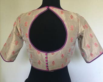 Saree blouse in dull gold color with small embroidered motif