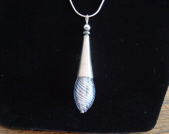 Fluted blown glass filled with a light feather pendant bead