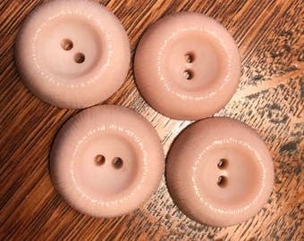 Set of four pale peach buttons
