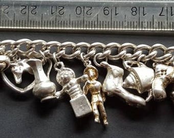 Silver charm bracelet Heart padlock clasp by Lionel Corper LC London 1990s 16 charms 64 grm 2.25 ounces
