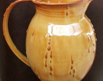 Handmade, wheel thrown, ceramic pottery pitcher with droplet texture.