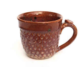 Burnt orange mug with black and green speckles