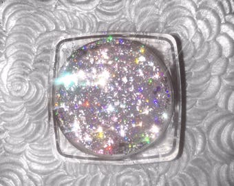 Shade name ( Prismatic ) . Holographic loose glitter pigment. 4 grams of product in a jar with sifter and seal.