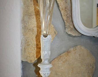 Weathered metal vase and a glass container