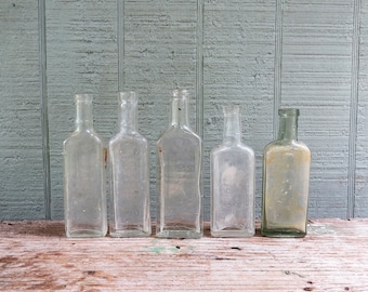 5 Antique Medicine/Apothecary Bottles- 4 Clear & 1 green Dr Tichenors