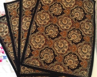 Bronze colored placemats with decorative stitching