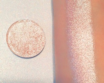 Shade name ( Peaches & Cream ). Light peach highlighter. Smooth, rich texture. Vegan and cruelty free.