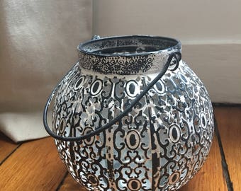 Gray and white wrought iron candle holder
