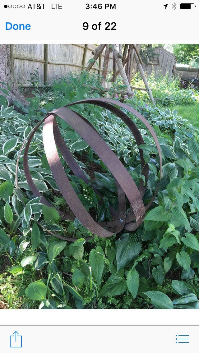Metal orb garden sculpture upcycled from vintage whiskey