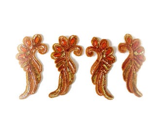 Four vintage orange sequin and bead appliques