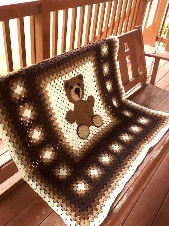 Crochet baby blanket with teddy bear on it. Proudly made in