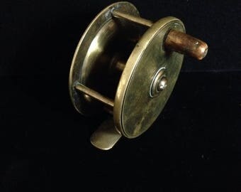 Antique brass fly fishing reel.