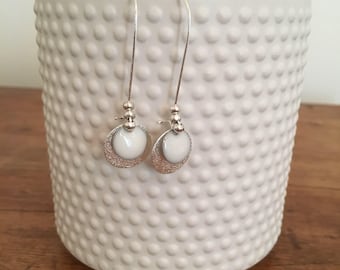 Silver earrings, sequins, glitter and glazed white