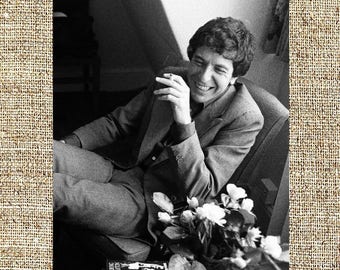 Leonard Cohen smiling, smoking and with flowers. black and white photo print, vintage photograph, rock music decor, gift for him or her