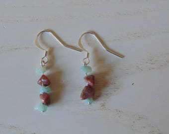 a pair of Silver earrings and stones gems.
