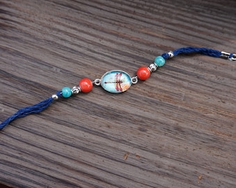 Navy blue corded bracelet with dragonfly charm, teal, silver and coral beads