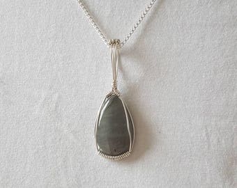 Pear shaped labradorite cabochon wrapped in silver filled wire. OOAK.
