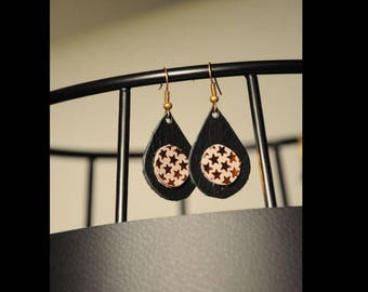 Cosmic earrings on black leather and grey stars