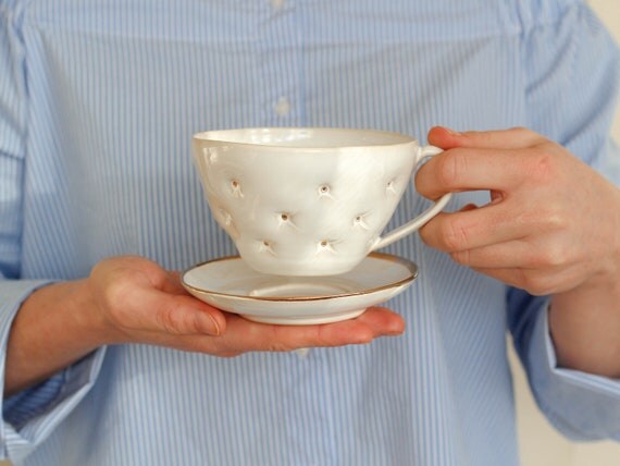 Delicate White Ceramic Cup And Saucer Handmade And Decorated