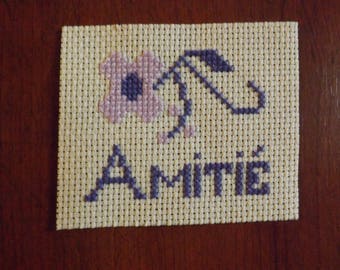 friendship flower embroidered on unbleached canvas