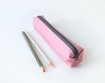 Small pencil case/zipper pouch in dusky pink with small white polka dots with a grey zip, lined with a grey fabric with off-white flowers
