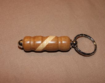 Keychain has been turned by hand in the elm Burl with ash inlay
