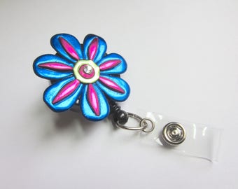 Whimsical flower Badge Reel in blue and fuchsia alligator or belt clip
