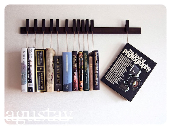 Custom made wooden book rack in Wenge. Movable pins.The pins also work as bookmarks.